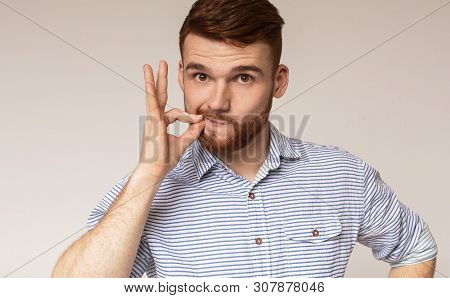 Secret Saver. Young Guy Locking Mouth Like Zip-lock On Studio Background, Panorama, Copy Space