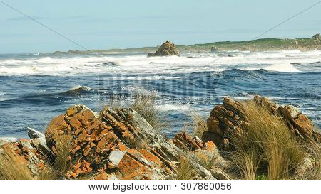 Red Rocks At The Arthur River Mouth On The West Coast Of Tasmania