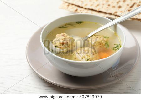 Bowl Of Jewish Matzoh Balls Soup On White Wooden Table