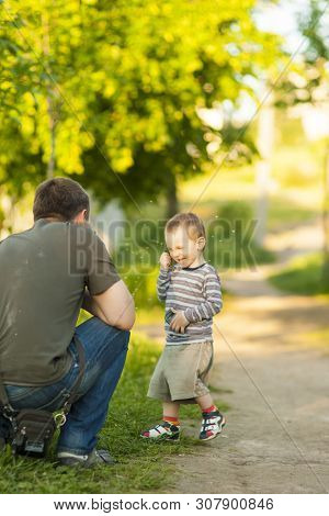 Father And Happy Son Playing Together Outdoors.