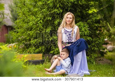 Portrait Of Loving Caucasian Mother With Her Son Outdoors. Posing Against Nature Background.horizont