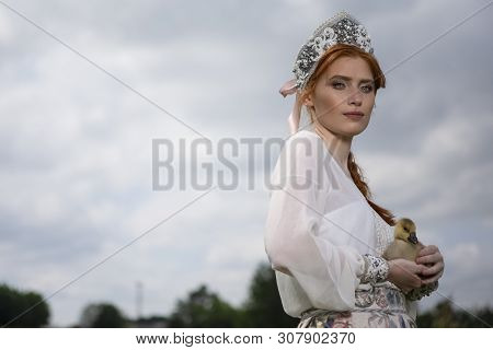 Fashion Portrait Of Young Caucasian Female Posing With Duckling In Russian Style Dress And  Kokoshni