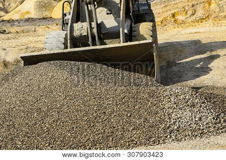 Tractor Collects Scoop With  Gravel. Excavator Extracts Sand And Gravel For  Concrete Mix.