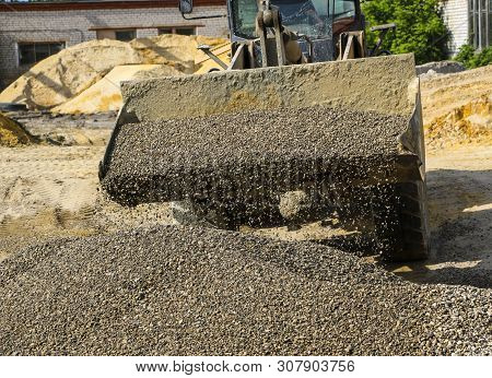 Tractor Collects Scoop With  Gravel. Excavator Extracts Sand And Gravel For  Concrete Mix.