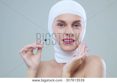Portrait Of Happy Young Woman After Her Lips Done Smiling And Using With Syringe