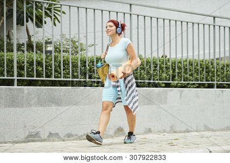 Smiling Happy Young Woman With Youga Mat Walking To Morning Fitness Class