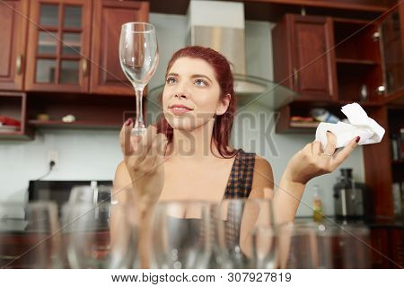 Young Woman With Ocd Looking At Champagne Fluter She Wiped With Paper Tower