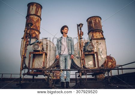 Urban Man With Hat Against The Background Of The City. Cool Guy. Wearing White Shirt And Jeans. Old 