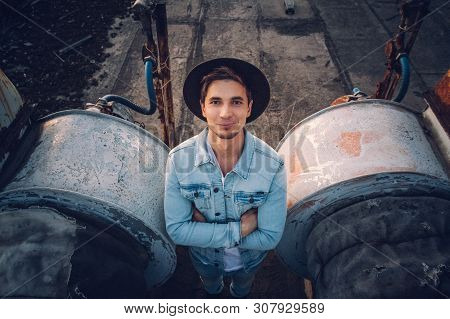 Urban Man With Hat Against The Background Of The City. Cool Guy. Wearing White Shirt And Jeans. Old 