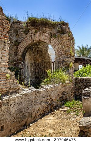 Antique Ruins In The Park On A Bright Sunny Day. Vertical.