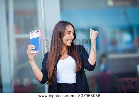 Travel. Woman Holding Two Air Ticket In Abroad Passport Near Airport