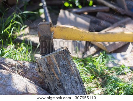 Old Rusty Ax Stuck In Old Rusty Ax Stuck In An Old Log, Chopping Wood.an Old Log, Chopping Wood.