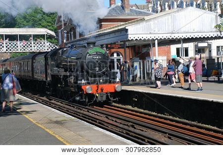 ST. LEONARDS-ON-SEA, ENGLAND - JUNE 22, 2019: London Midland and Scottish Railway Class 5 steam locomotive, 44871, hauls an excursion train. Designed by William Stanier, it was built in 1945.