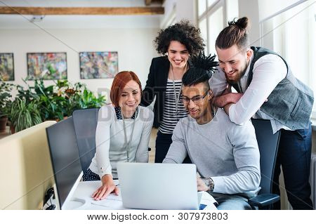 Group Of Young Businesspeople Working In Office, Start-up Concept.
