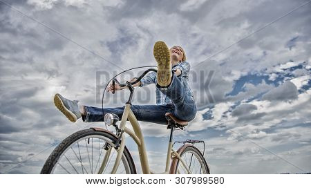 Woman Feels Free While Enjoy Cycling. Girl Rides Bicycle Sky Background. Cycling Gives You Feeling O