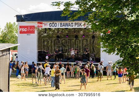 Music Scene On Danube Island. People Gathering To Listen To The Music Band In Vienna Austria