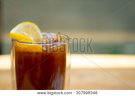 Glass Of Espresso Shot Mixed With Orange Juice And Topped With Fresh Sliced Orange