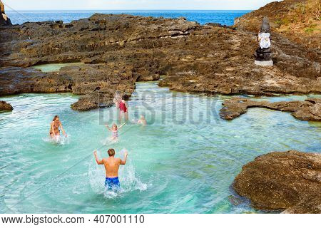 Family Beach Holiday Lifestyle. Happy People Have Fun In Natural Sea Pool At Angel's Billabong On Pa