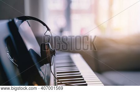 Soft Focus Digital Piano Keyboard With Headphones For Music With Blurry Of Sofa Background, Cosy Cin