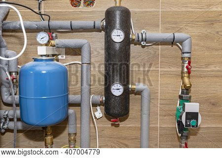 Expansion Vessel Protecting Against Pressure In A Modern Boiler Room Lined With Ceramic Tiles For Na