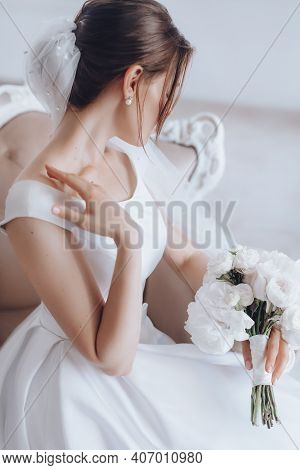 Stock Photo - Fashion Photo Of Gorgeous Bride In Luxurious Wedding Dress Posing At Bedroom. Morning 