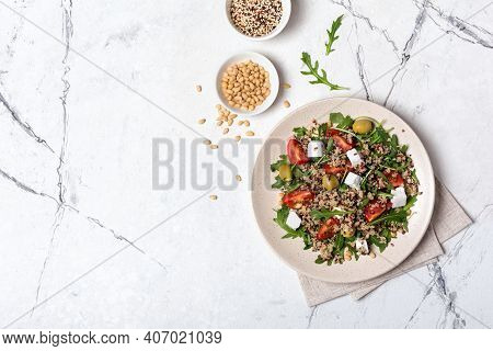 Healthy Vegetarian Salad With Cooked Chia Seeds, Fresh Arugula, Cherry Tomatoes, Soft Cheese And Oli