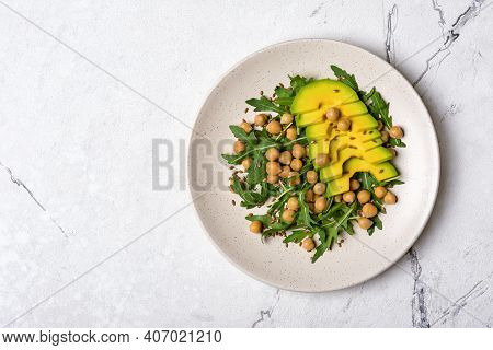 Healthy Vegetarian Food: Cooked Chickpeas With Fresh Arugula And Avocado