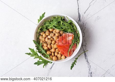 Bowl Of Healthy Food: Cooked Chickpeas With Fresh Arugula And Salmon Fish
