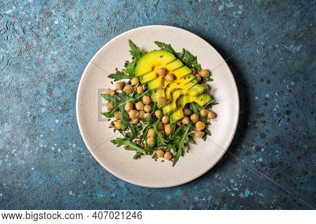 Healthy Vegetarian Food: Cooked Chickpeas With Fresh Arugula And Avocado