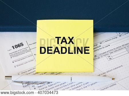 Tax Form 1065 With Yellow Sticker With Text Tax Deadline. Notepad And White Pen