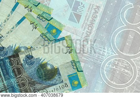 500 Kazakhstani Tenge Bills Lies In Stack On Background Of Big Semi-transparent Banknote. Abstract B