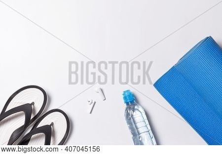 Layout With Individual Accessories For Yoga, Bodyflex, Gymnastics. Yoga Mat, Water Bottle, Wireless 