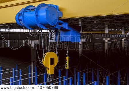 Overhead Traveling Cathead With Steel Hooks In The Factory Floor