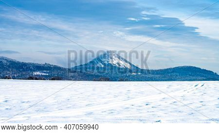 Winter Hilly Landscape Of Lusatian Mountains With Klic Mountain In The Middle. Czech Republic