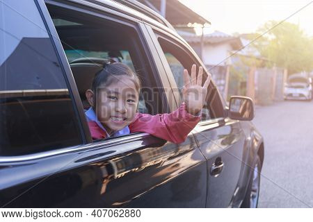 On The Way To School, The Little Girl Stretched Out His Hand From The Car Window, Laughing And Smili