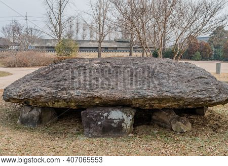 Dolmen Burial Chamber With Large Boulder Used As Capstone On Top Of Smaller Stones In Neolithic Park