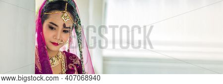 Panoramic Picture Portrait Asian Woman In A Margenta Indian Tradition Sari, She Is Looking At Down A