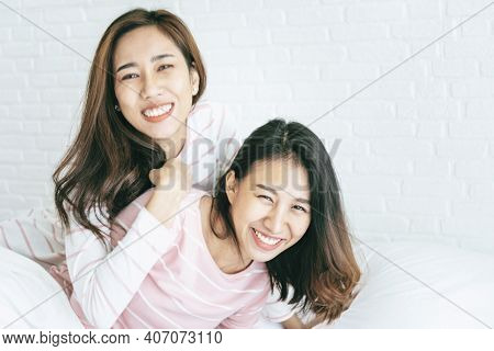 Two Pretty Best Friends Forever Girlfriend Talk, Hug And Laugh Together On Bed At Cozy Home Relation