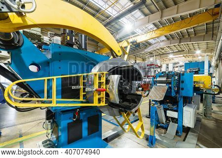 Cold Rolled Steel Coil On Decoiler Of Machine In Metalwork Manufacturing. Modern Equipment For Sheet