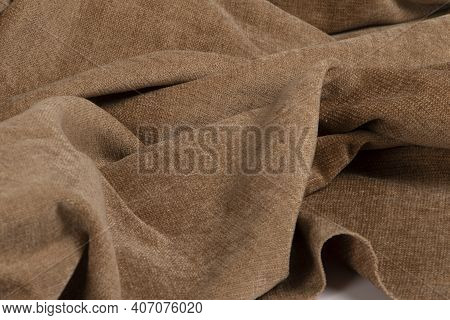 A Closeup Of A Wrinkled Natural Brown Chenille Fabric Texture