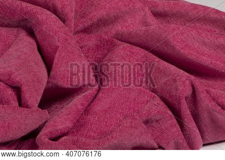 A Closeup Of A Wrinkled Natural Pink Chenille Fabric Texture