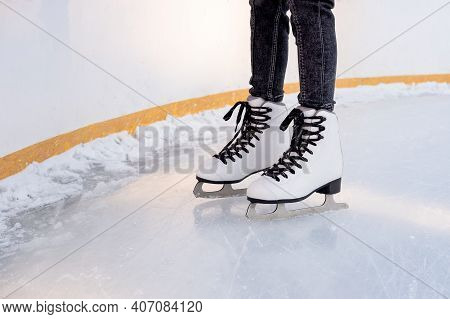 Children's Feet In Skates On The Ice Rink.