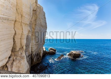 Israel. The color of sea water changes from azure to dark blue. Karst cave Rosh-a-Nikra on the shores of the Mediterranean Sea. The concept of active, environmental and photo tourism