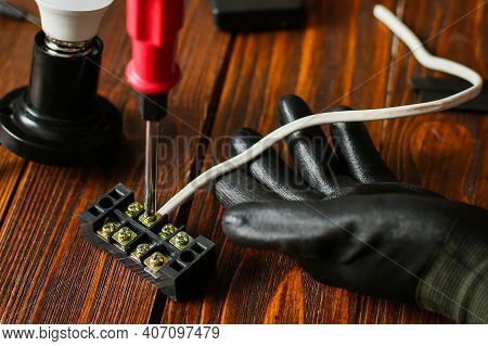 Electrician Hands Connecting Wires In Terminal Block. Connection Of Wires With Clamps. An Electricia