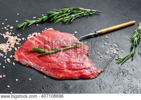 Raw Flat Iron Steak With Rosemary And Pink Salt. Fresh Marble Beef Meat Black Angus. Black Backgroun