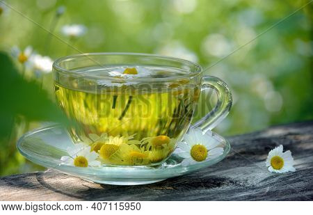 Cup Of Chamomile Tea On A Wooden Table. Herbal Tea. Cold And Flu Remedy.  Seletive Focus