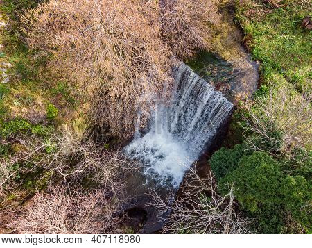Aerial View Of A Mountain Stream Cascading Over A Waterfall Near Feliceto In The Balagne Region Of C