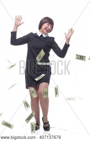 happy businesswoman dancing in the rain of banknotes.