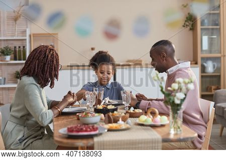 Portrait Of Modern African -american Family Enjoying Dinner Together While Celebrating Easter At Hom