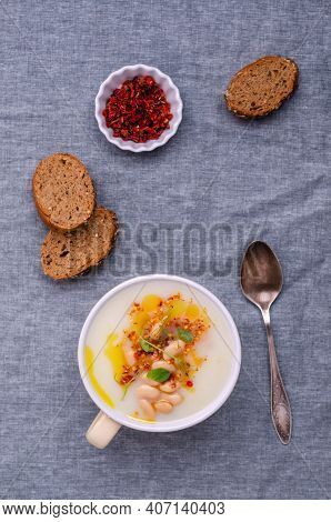 Vegetable Cream Soup With Beans And Spicy Oil In A Bowl On A Textile Background. Selective Focus.